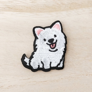 May include: White embroidered iron-on patch of a cartoon dog with black eyes, a pink nose and tongue, and a black outline.