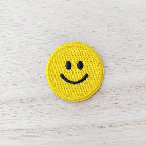 May include: Yellow embroidered smiley face patch.