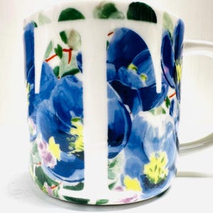 May include: A set of three ceramic mugs with a speckled, matte finish. The mugs are in shades of cream, light gray, and dark gray. Each mug has a simple, minimalist design and a rounded handle.