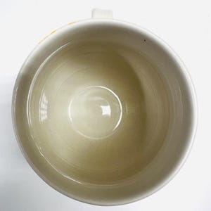 May include: A trio of ceramic mugs with a speckled, matte finish in cream, light grey, and dark grey. Each mug features a simple, minimalist design, ideal for tea or coffee.