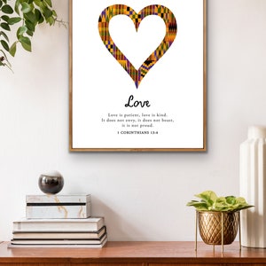 May include: A printable wall art design featuring a heart shape made of colorful African print fabric. The text "Love" is written in a decorative font below the heart, followed by a quote from 1 Corinthians 13:4: "Love is patient, love is kind. It does not envy, it does not boast, it is not proud."