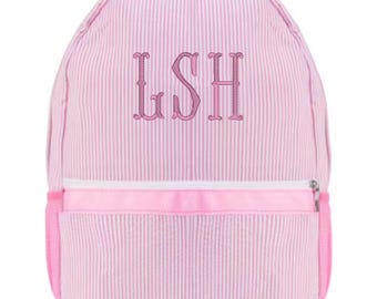 May include: Pink and white striped backpack with a front zippered pocket and side pocket. The backpack has a pink handle and straps. The initials "LSH" are embroidered in pink on the front of the backpack.
