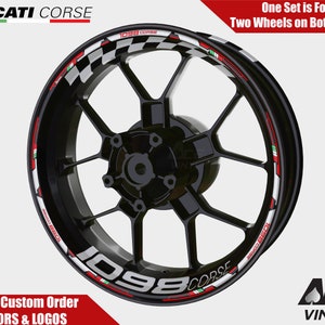 May include: Black motorcycle wheel rim with a white and red checkered stripe and the text "1098 CORSE" in white with red accents. The stripe also features the Italian flag colors of green, white, and red.