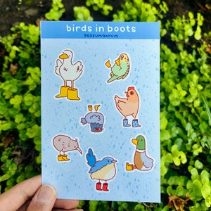 May include: A sheet of stickers featuring various birds wearing boots. The stickers are on a light blue background with a white border. The text "birds in boots" and "possumonium" is printed at the top of the sheet.