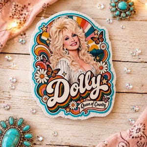 May include: A die-cut sticker featuring a portrait of Dolly Parton with blonde hair, surrounded by colorful retro-style rainbows, daisies, and butterflies. The text reads Dolly and Queen of Country in a bold, stylized font against a white background.