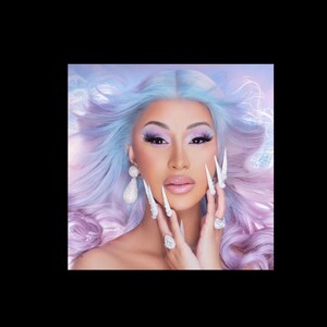 May include: Portrait of a person with light skin, wearing a light blue and purple wig. The person has long, white, pointed fingernails, and is wearing large, sparkling earrings and rings. The person has pink lipstick and purple eyeshadow.