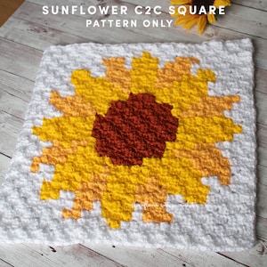 May include: A crochet square featuring a sunflower design in yellow, orange, and brown. The background is white. The text "SUNFLOWER C2C SQUARE PATTERN ONLY" is at the top of the square.