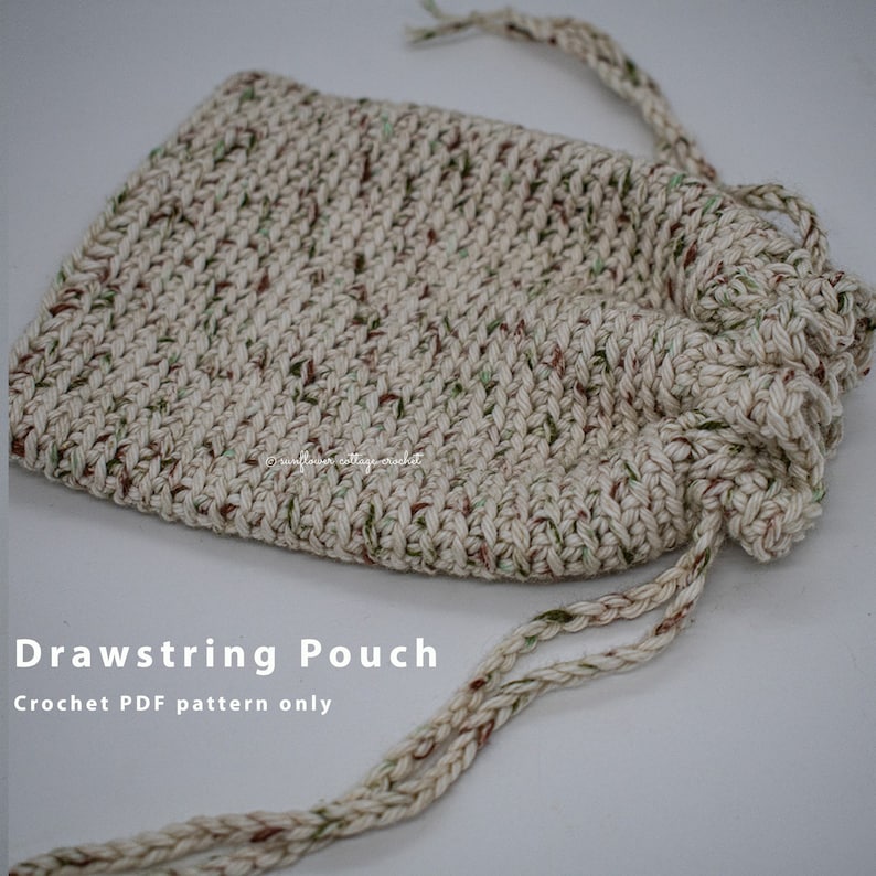 May include: A crocheted drawstring pouch with a beige, green, and brown speckled yarn. The pouch is closed and the drawstring is hanging loose. The text "Drawstring Pouch" and "Crochet PDF pattern only" is below the pouch.