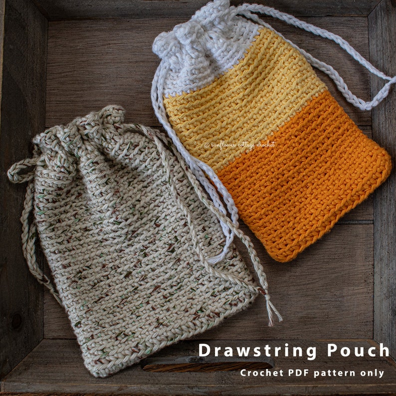 May include: Two crocheted drawstring pouches, one in a beige speckled yarn and the other in white, yellow, and orange stripes. The pouches are sitting on a wooden surface. The text "Drawstring Pouch Crochet PDF pattern only" is below the pouches.