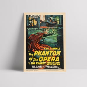 May include: A vintage movie poster for "The Phantom of the Opera" starring Lon Chaney. The poster features a dramatic image of the Phantom in a red cape, emerging from the water. The text on the poster is in yellow and black.