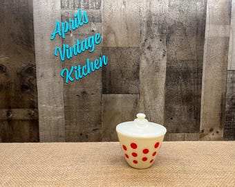 May include: A vintage cream-colored kitchen canister with a lid and red polka dots. The canister has a rounded shape and a small knob on top. The words "Aprils Vintage Kitchen" are in turquoise script in the background.
