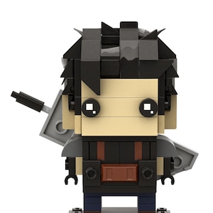 May include: A black and gray Lego minifigure of a character with black hair, a black shirt, brown pants, and a gray sword on their back. The minifigure is standing on a black Lego base.