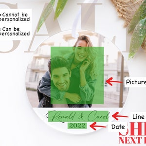 May include: A round, clear bauble with a photo of a couple. The photo shows a woman with long brown hair, wearing a blue denim jacket, and a man with short brown hair, wearing a black jacket. The text "Ronald & Carol 2022" is written on the bauble.