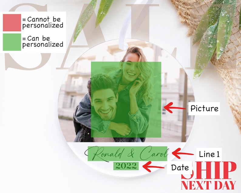 May include: A round, clear bauble with a photo of a couple. The photo shows a woman with long brown hair, wearing a blue denim jacket, and a man with short brown hair, wearing a black jacket. The text "Ronald & Carol 2022" is written on the bauble.