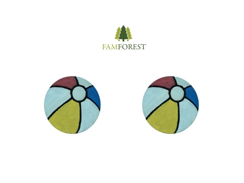 May include: Two round, colorful beach ball designs. Each ball features segments of red, blue, yellow, and light blue, separated by black lines. The design is reminiscent of a classic beach ball.