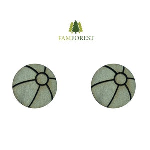 May include: Two round, light-colored wooden earrings with a black geometric design. The earrings have a circular center and black lines radiating outwards. The brand name "FAMFOREST" is above the earrings.