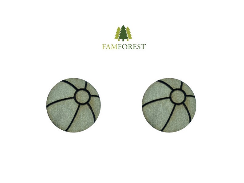 May include: Two round, light-colored wooden earrings with a black geometric design. The earrings have a circular center and black lines radiating outwards. The brand name "FAMFOREST" is above the earrings.