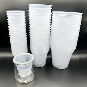 May include: A stack of clear plastic plant pots, with a smaller stack of pots and a clear glass pot with drainage holes.