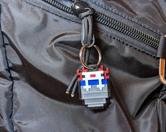 Minecraft-inspired Axolotl in a Bucket keyring. Decorations for backpacks, lunchbags, keychains, ornament