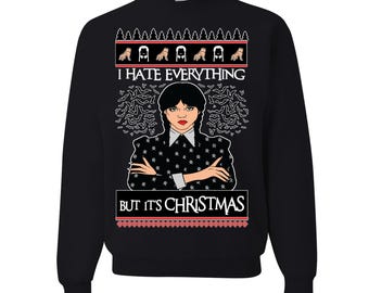 May include: Black sweatshirt with a graphic of a woman with black braids and the text "I HATE EVERYTHING BUT IT'S CHRISTMAS". The design includes bats and a red and white border.