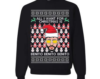 May include: Black sweatshirt with a festive design. The graphic features a cartoon image of a person wearing a Santa hat and sunglasses, with the text "ALL I WANT FOR CHRISTMAS IS" and "BENITO BENITO BENITO".