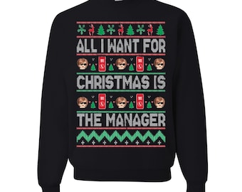 May include: Black crew neck sweatshirt with a festive Christmas design. The design includes the text "ALL I WANT FOR CHRISTMAS IS THE MANAGER" in white, red, and green. The design also features images of a person wearing sunglasses, a 911 phone, snowflakes, and Christmas trees.