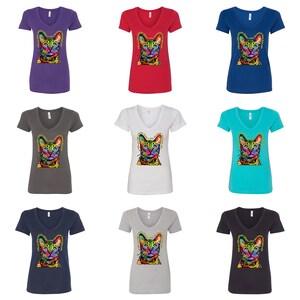 May include: Nine different colored V-neck t-shirts with a colorful abstract cat design on the front. The shirts are available in purple, red, blue, gray, white, turquoise, navy blue, gray, and black.