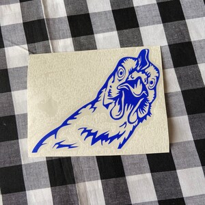May include: A blue vinyl decal of a chicken's head with its beak open, looking directly at the viewer. The decal is on a white background.