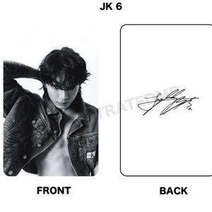 May include: Black and white photo card featuring a man wearing a denim jacket with his hair covering his forehead. The back of the card has a black and white signature.