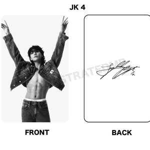 May include: Black and white photo of a person wearing a denim jacket and jeans. The person is posing with their arms raised. The photo is signed "JK 4" in black ink.