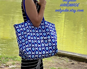 Bolso grande de lona con diseño de ojo malvado: resistente al agua, ideal para playa, piscina y viajes.