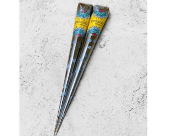 May include: Two brown henna cones with blue polka dots and yellow labels that say "Zubaida Henna".