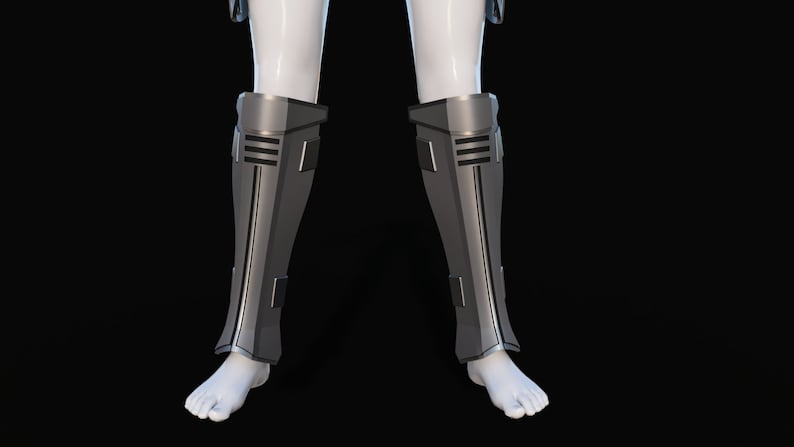 May include: A pair of silver-colored shin guards with black accents. The guards are made of a hard material and have a sleek, futuristic design.