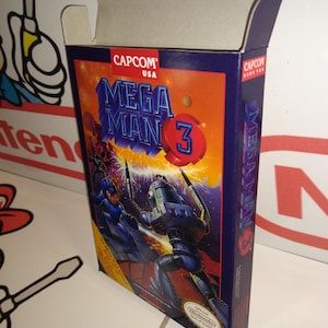 May include: A blue and orange box for the Nintendo Entertainment System video game Mega Man 3. The box features a picture of Mega Man fighting a robot enemy. The text on the box reads "CAPCOM USA MEGA MAN 3" and "Official Nintendo Seal of Quality".