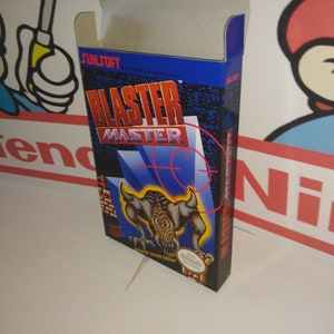 May include: A blue and black Nintendo Entertainment System game cartridge box with a grey top. The box features a graphic of a monster with horns and the text "Blaster Master" in red and white.