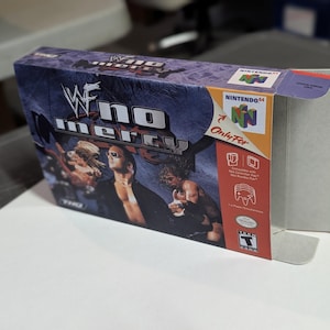 May include: A blue and white Nintendo 64 game case with the title "WWF No Mercy" and a picture of wrestlers on the front. The case is for the Nintendo 64 console.
