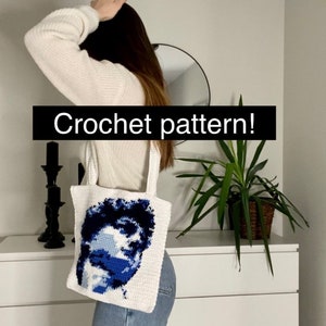 May include: A white crochet tote bag with a blue and white portrait of a person. The text "Crochet pattern!" is written in black on a white background.