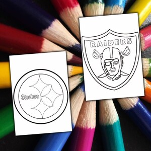 May include: Two white cards with black line drawings of sports team logos, one for the Steelers and one for the Raiders, are displayed against a background of colourful pencils arranged in a circular pattern.