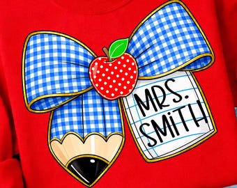 May include: Red sweatshirt featuring a school-themed graphic. The design includes a blue and white gingham bow, a red apple with white polka dots, and a pencil. The text "MRS. SMITH" is written on a notepad.