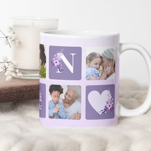 May include: White ceramic mug featuring a personalized design with photos and a floral initial "N". The mug has a lavender background with square photo frames and a white handle. A candle and flowers are in the background.