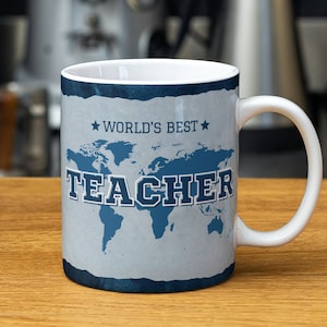 May include: White ceramic mug with a blue and white world map design. The text "WORLD'S BEST TEACHER" is printed in blue on the mug.