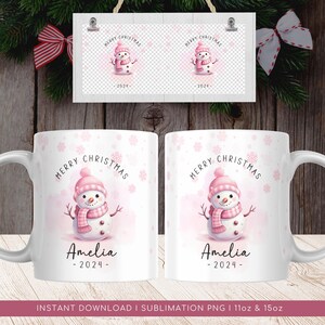 May include: A white ceramic mug with a pink snowman design and the text "Merry Christmas" and "Amelia - 2024 -" printed on it. The mug is decorated with a snowflake pattern.