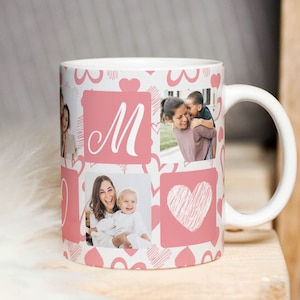 Könnte beinhalten: Weiße Keramiktasse mit einem rosa-weißen Design mit Herzen und Fotos. Die Tasse hat den Buchstaben "M" in einem rosa Quadrat.