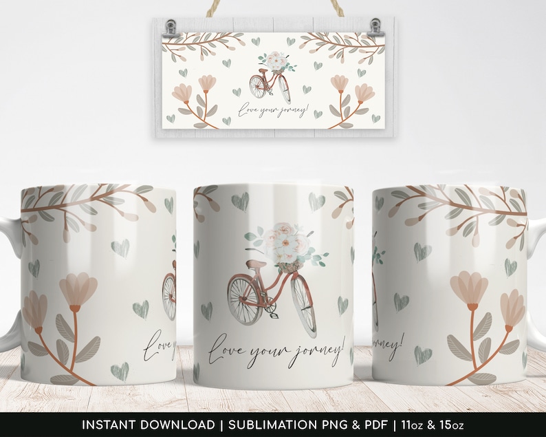 May include: White ceramic mug with a floral design and a bicycle with flowers in the basket. The text "love your journey!" is printed on the mug.