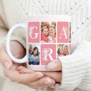 May include: White ceramic mug with a pink background and a collage of photos of a grandmother and granddaughter. The photos are arranged to spell out the word "Grandma" with floral accents.