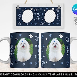 May include: Two white ceramic mugs with a navy blue design. The design features paw prints, hearts, and stars. Each mug has a circular space for a photo of a dog. The photo shows a white dog with blue eyes and a blue bow.