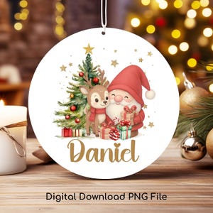 May include: A round Christmas ornament featuring a festive design. The ornament showcases a watercolor illustration of Santa Claus, a reindeer, and a Christmas tree. The name "Daniel" is written in gold script. The words "Digital Download PNG File" are at the bottom.