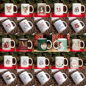 May include: An assortment of white ceramic mugs with Christmas designs. Some mugs feature reindeer, snowmen, and festive text. Others display family photos or personalized names. The mugs are arranged on a bed of brown decorative material.