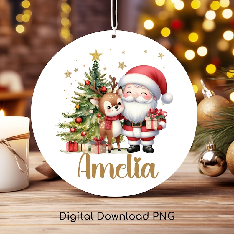 May include: A round Christmas ornament featuring a festive illustration of Santa Claus, a reindeer, and a Christmas tree. The ornament has the name "Amelia" in gold script. The words "Digital Download PNG" are at the bottom.