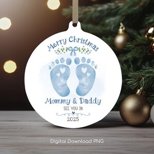 May include: White round Christmas ornament with blue footprints, green leaves, a blue bow, and the text "Merry Christmas Mommy & Daddy See You In 2025".